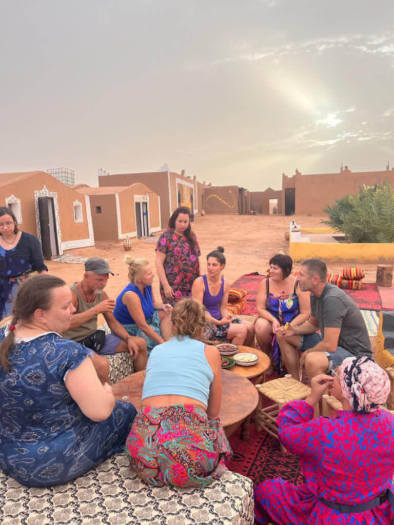 Guests relaxing at Desert Camp Morocco courtyard